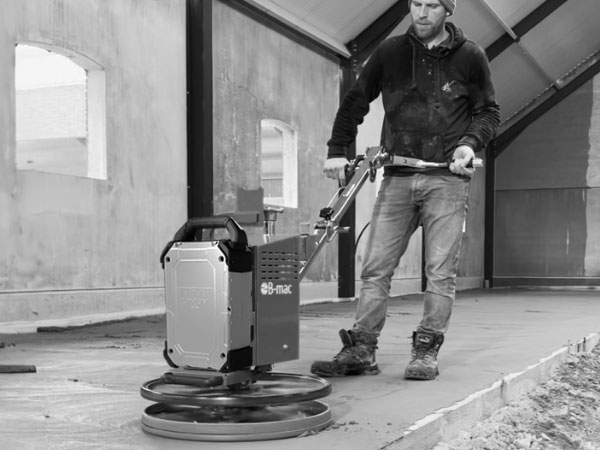Man operating a concrete trowel powered by a Vanguard Swappable Battery